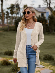 Beige ribbed knit longline button-down cardigan with pockets and cuffed sleeves.