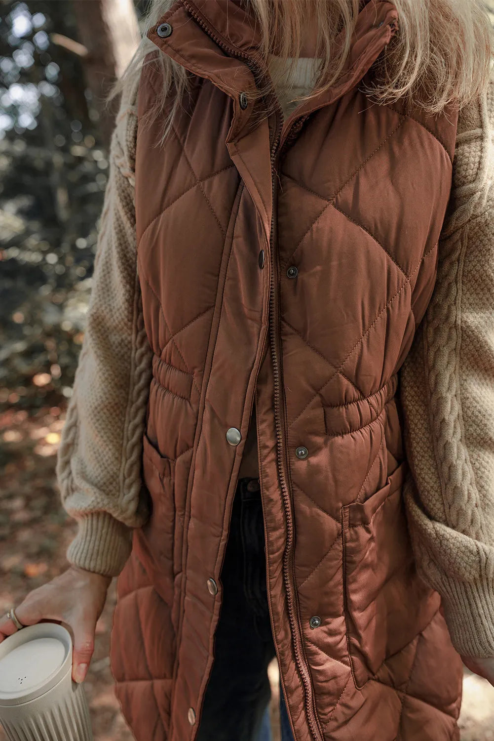 Brown diamond quilted longline vest with cinched waist detail and pockets