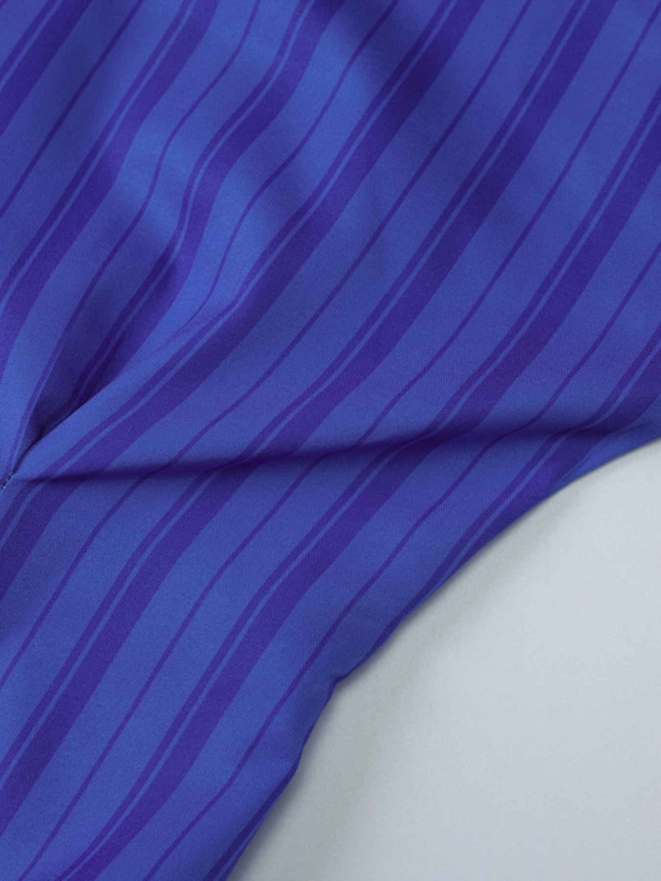 Button-down mini dress in blue with darker blue stripes, close-up detail