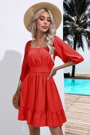 Red mini dress with square neck, puff sleeves, belted waist, and ruffled hem.