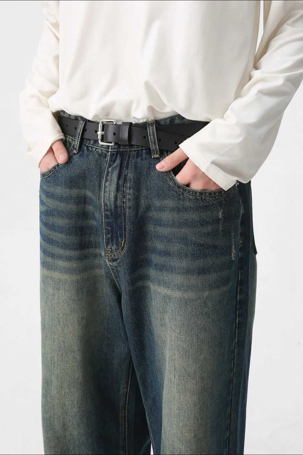 Faded wash wide-leg denim jeans in medium with a relaxed fit and distressed details.