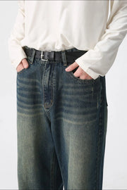 Faded wash wide-leg denim jeans in medium with a relaxed fit and distressed details.