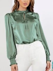 Gum Leaf satin blouse with tie-neck, ruffled collar, puff sleeves, and shirred cuffs.