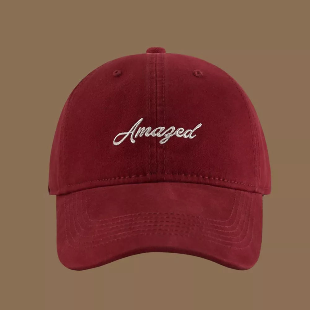 Wine red cotton baseball cap with white embroidered "Amazed" text.