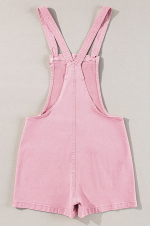 Blush pink denim short overalls with adjustable straps and a casual cut.