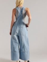 Light blue denim overalls with wide legs and raw hem detail, worn with a grey tank top.