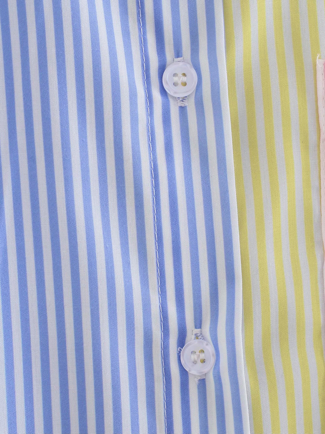 Colorblock striped oversized button-down shirt with blue, yellow, and pink panels and white buttons.