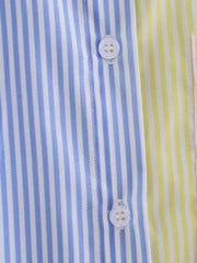 Colorblock striped oversized button-down shirt with blue, yellow, and pink panels and white buttons.