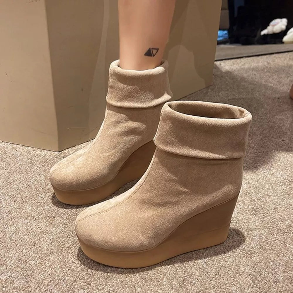 Apricot suede wedge boots with folded cuffs and platform sole.