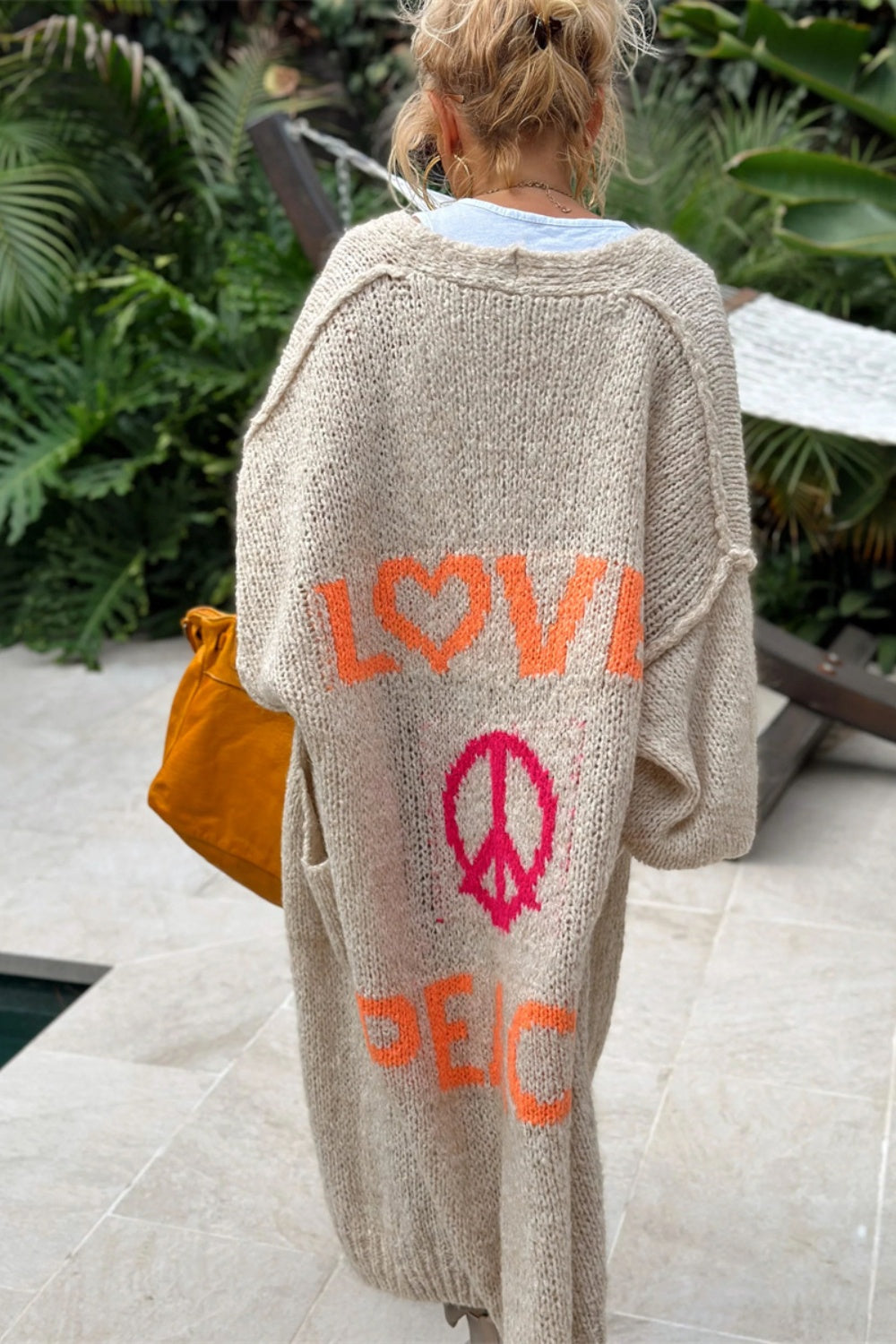 Khaki knit maxi cardigan with orange LOVE graphic and pink peace sign.