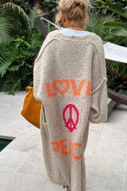 Khaki knit maxi cardigan with orange LOVE graphic and pink peace sign.