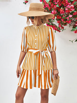 Vertical stripe shirred waist dress in gold with tie belt and tiered skirt.