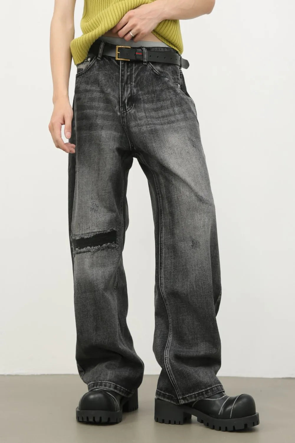 Baggy fit dark washed denim jeans with knee rips and a comfortable casual style.