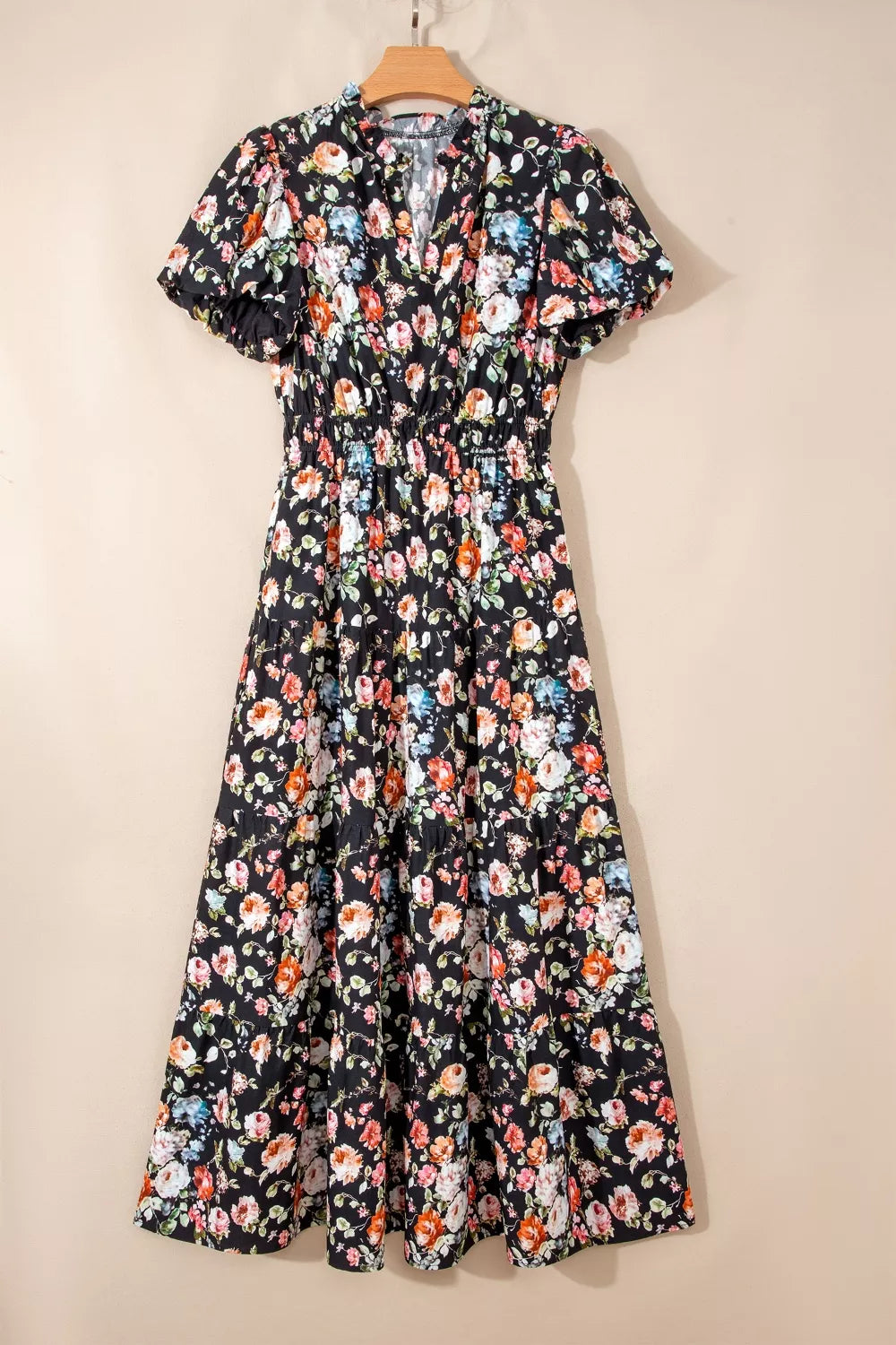 Floral tiered maxi dress with smocked waist and short puff sleeves.