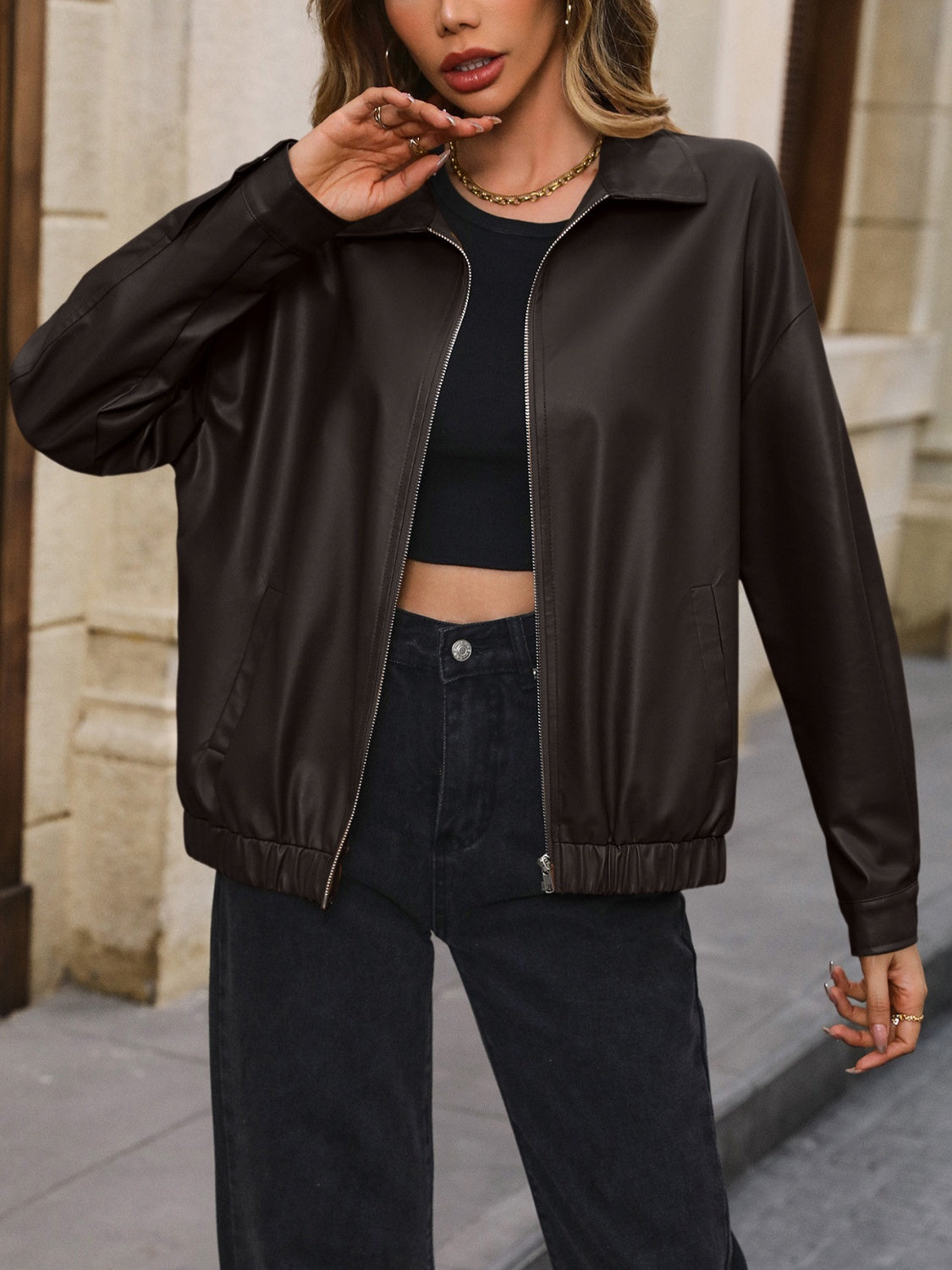 Brown faux leather bomber jacket with zip front and elastic cuffs
