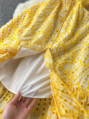 Yellow lace-embroidered tiered cami dress with eyelet details and a white lining.