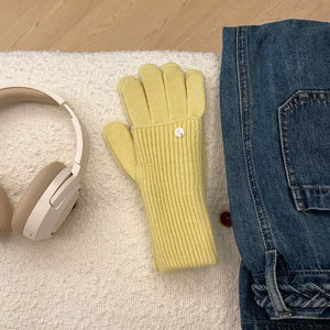 Yellow ribbed knit convertible gloves with a small button detail.