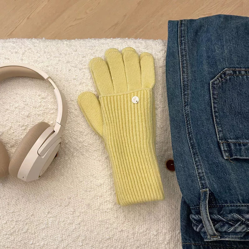 Yellow ribbed knit convertible gloves with a small button detail.