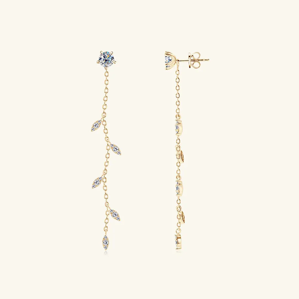 Gold dangling crystal vine earrings with delicate chain and leaf-shaped accents.
