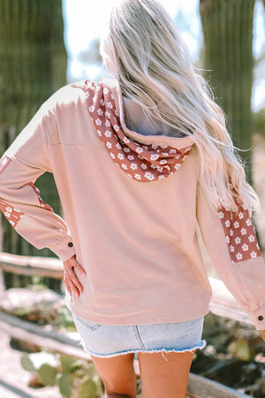 Dusty pink hoodie with floral patchwork on hood and sleeves, button details.