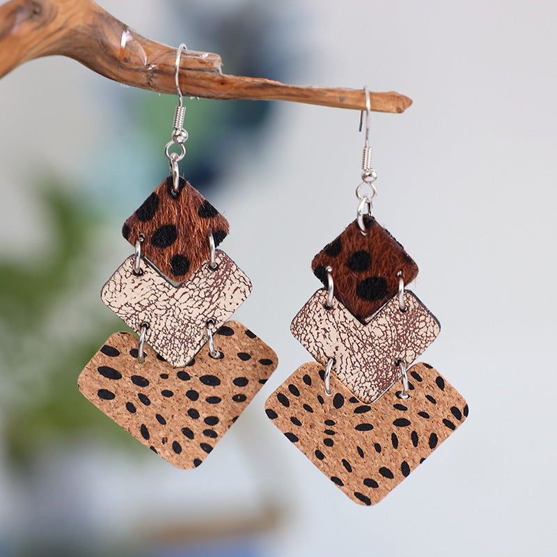 Textured leopard print drop earrings in tan and dark brown with diamond shapes.