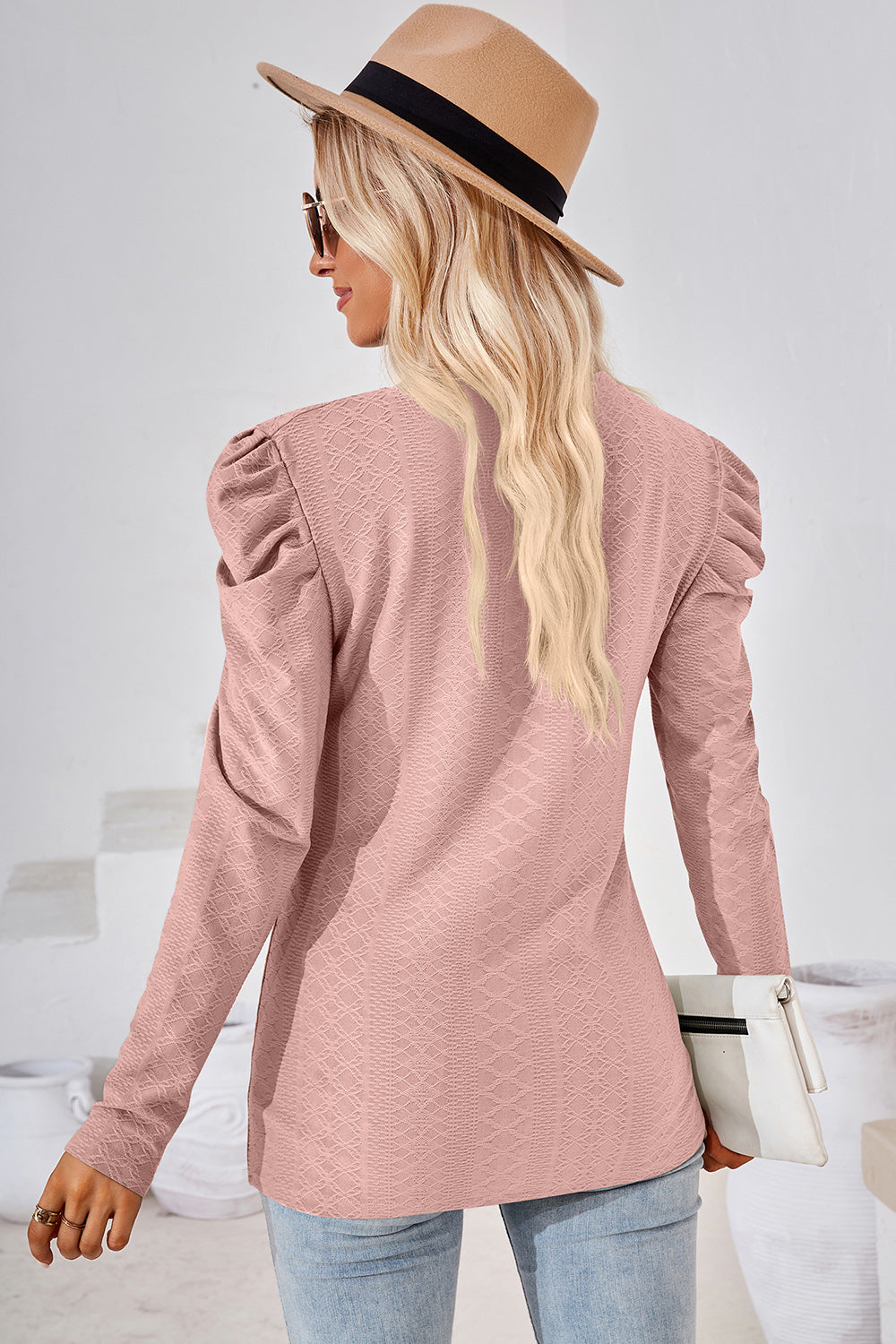 Blush pink textured puff-sleeve crew neck top with diamond pattern.