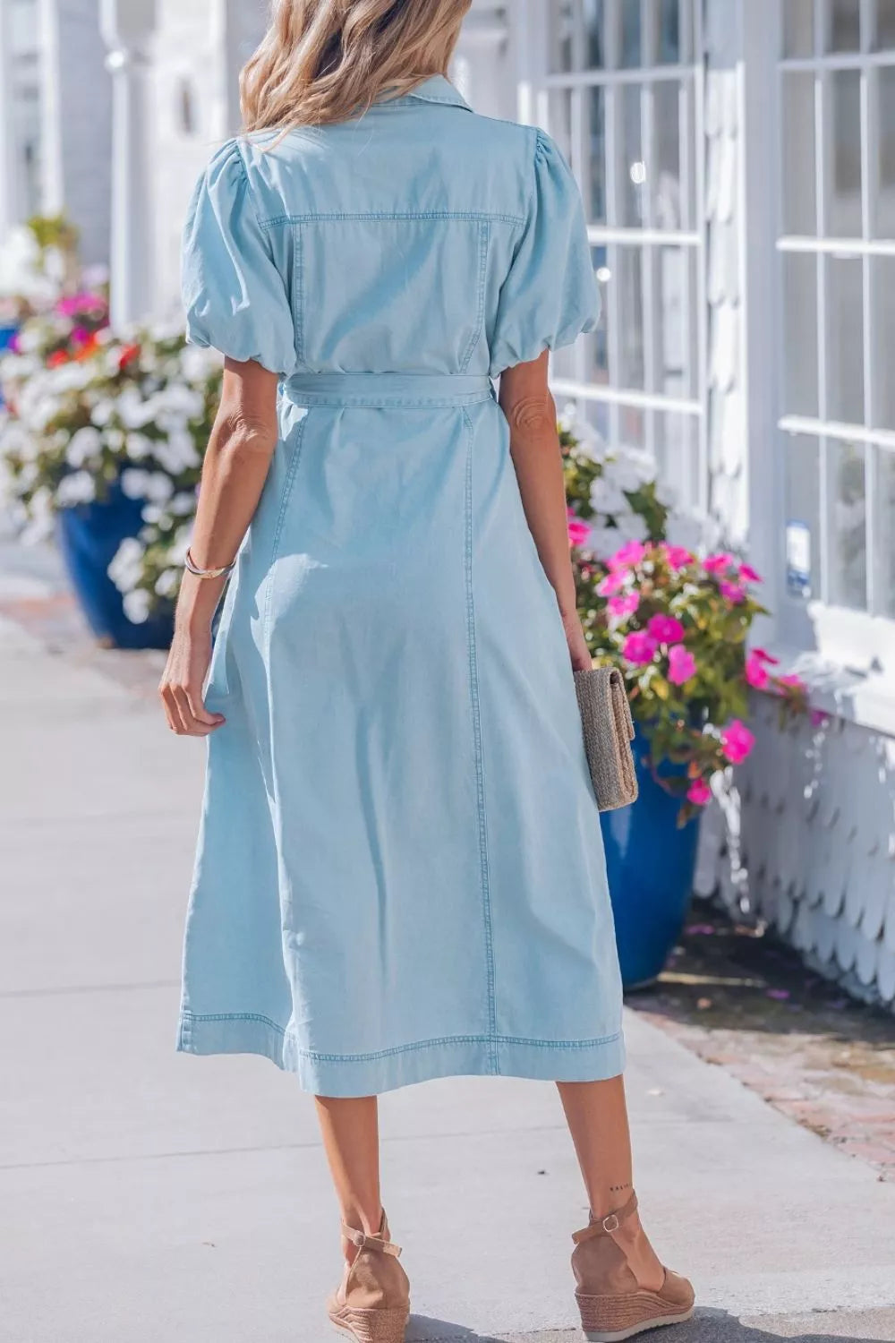 Light blue denim midi dress with collar, puff sleeves, and belted waist.