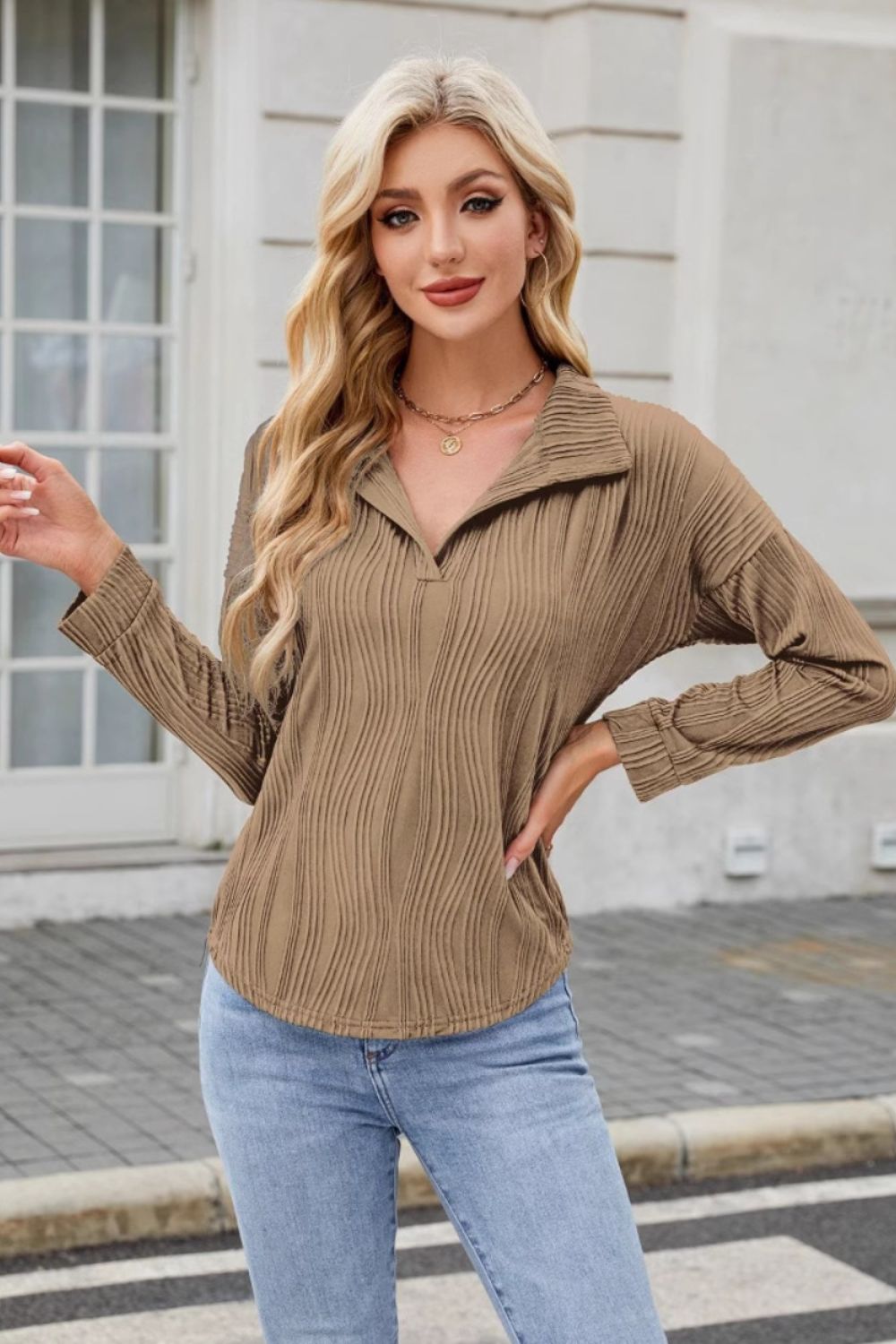 Taupe wave-effect collared long sleeve blouse with a V-neck and textured fabric.