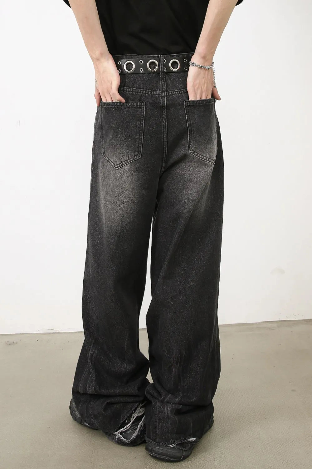 Dark balloon-leg denim jeans with subtle fade and distressed hem