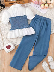 White puff sleeve blouse with blue smocked bodice and wide-leg blue pants set.