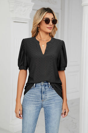 Black perforated puff sleeve keyhole blouse with a V-neckline and textured pattern.