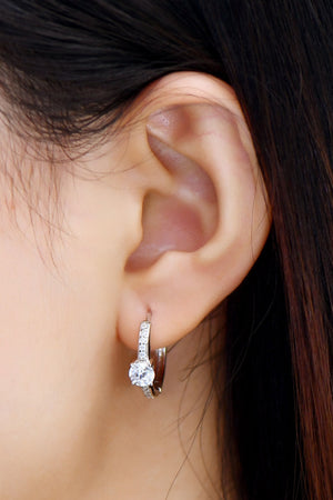 Silver pavé halo moissanite hoop earrings with a central round-cut stone.