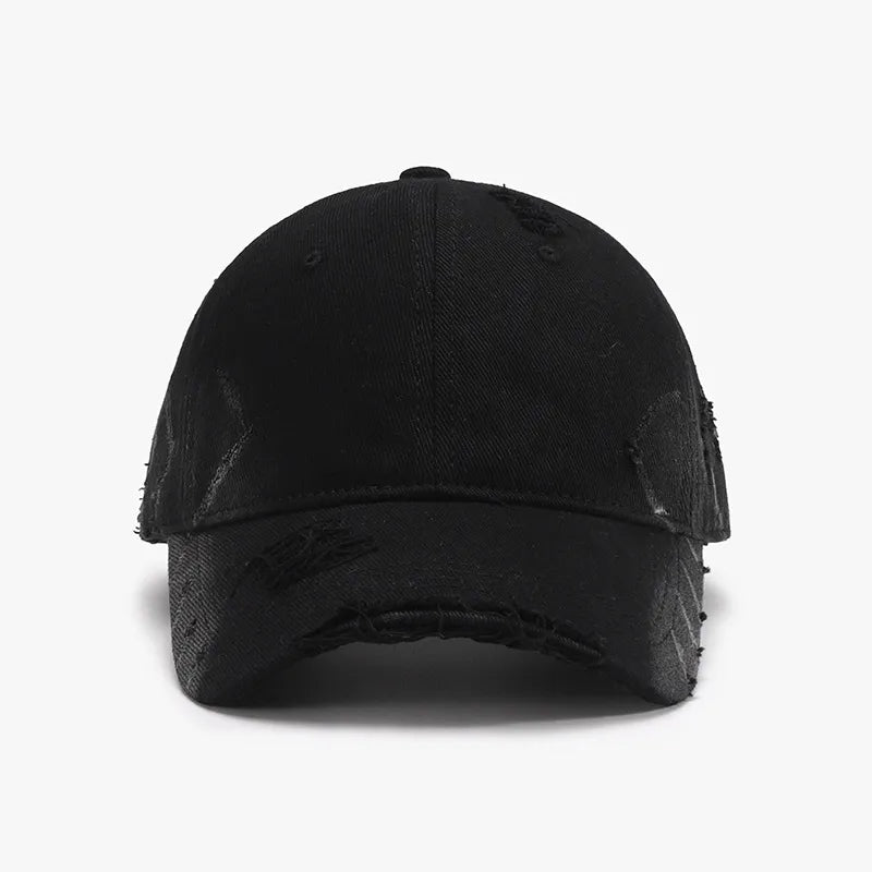 Black distressed denim baseball cap with frayed edges and subtle pattern details.