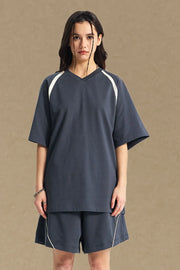 Navy V-neck raglan tee with white contrast shoulder detail.
