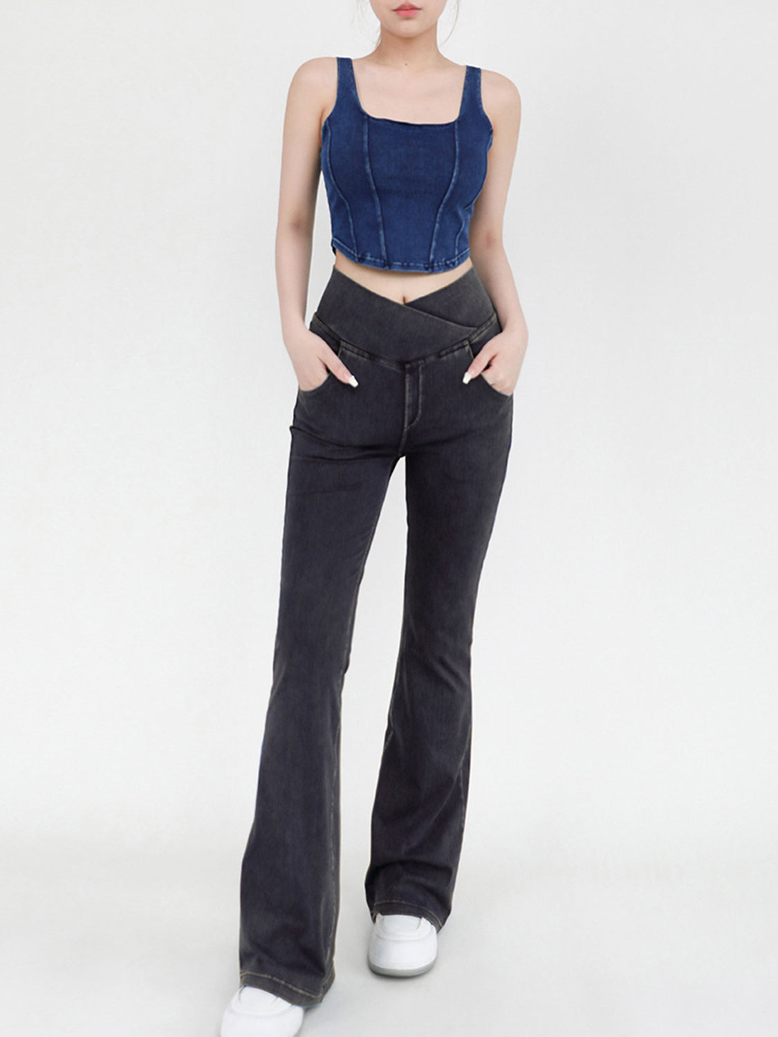 Charcoal crossover waist flare jeans with a v-shaped front detail.