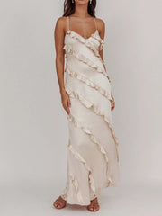 Beige ruffled spaghetti strap maxi dress with diagonal ruffle details.