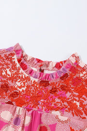 Floral embroidered yoke blouse with ruffle neckline and colorful print.
