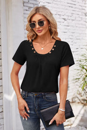 Black short sleeve top with gathered yoke and button trim, crew neck