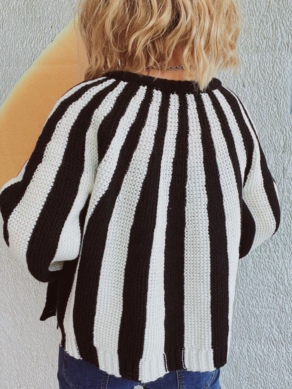 Bold stripe knit cardigan in black and white acrylic with a button-up front.