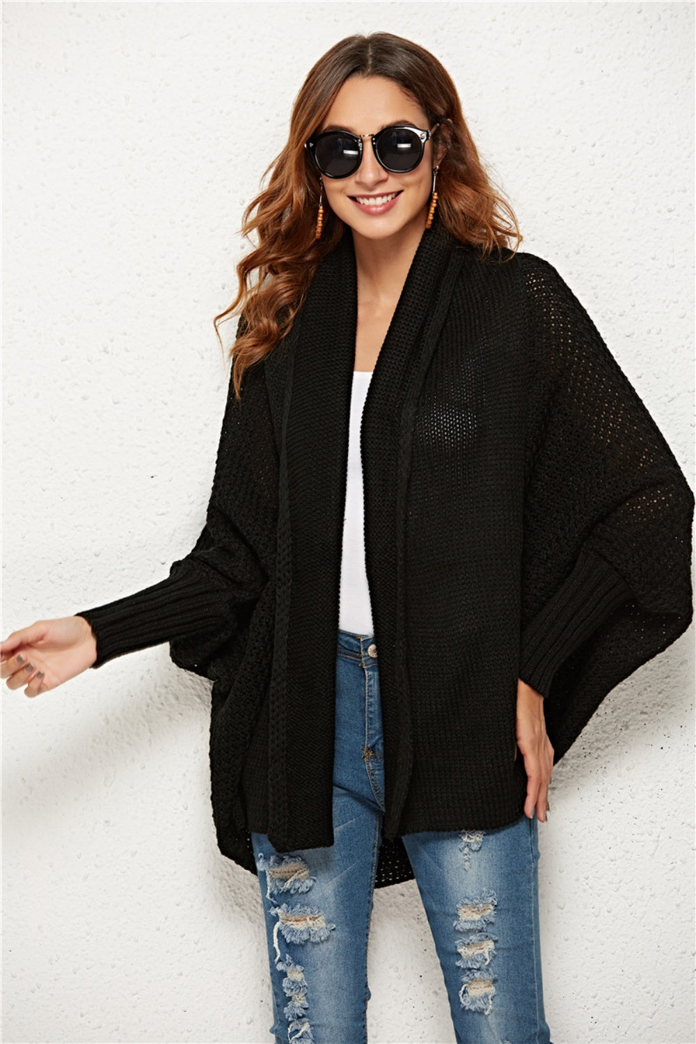 Black textured cocoon knit cardigan with batwing sleeves and open front.