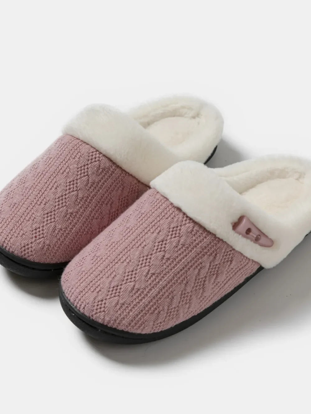 Dusty Pink cable knit shearling house slippers with faux fur lining and button detail.
