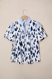 Vibrant abstract print polyester shirt with ruffled sleeves, V-neck and buttoned front.