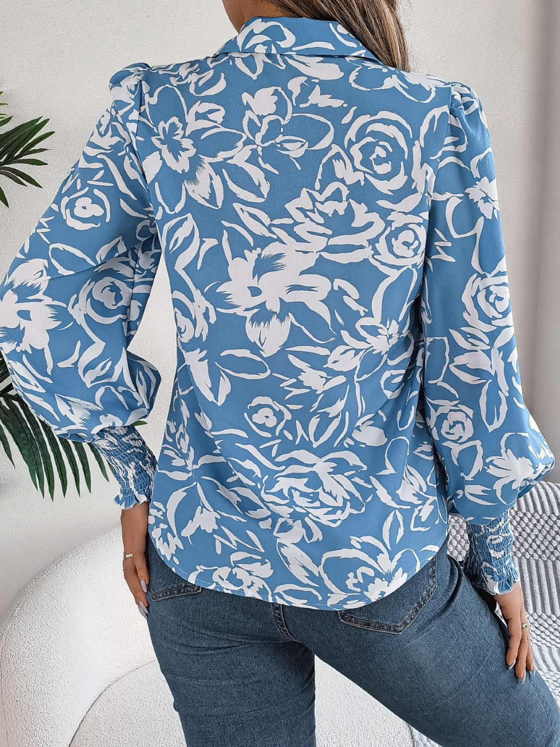 Light blue floral print blouse with shirred cuffs and puff sleeves.