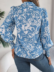 Light blue floral print blouse with shirred cuffs and puff sleeves.