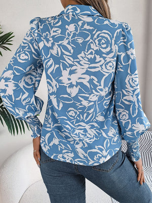 Light blue floral print blouse with shirred cuffs and puff sleeves.