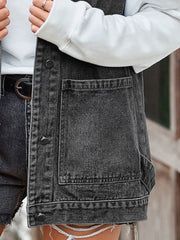 Black denim vest with patch pockets and button front, styled with a white hoodie.