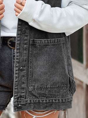 Black denim vest with patch pockets and button front, styled with a white hoodie.
