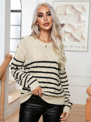 Beige cable-knit sweater with black stripes and shoulder buttons