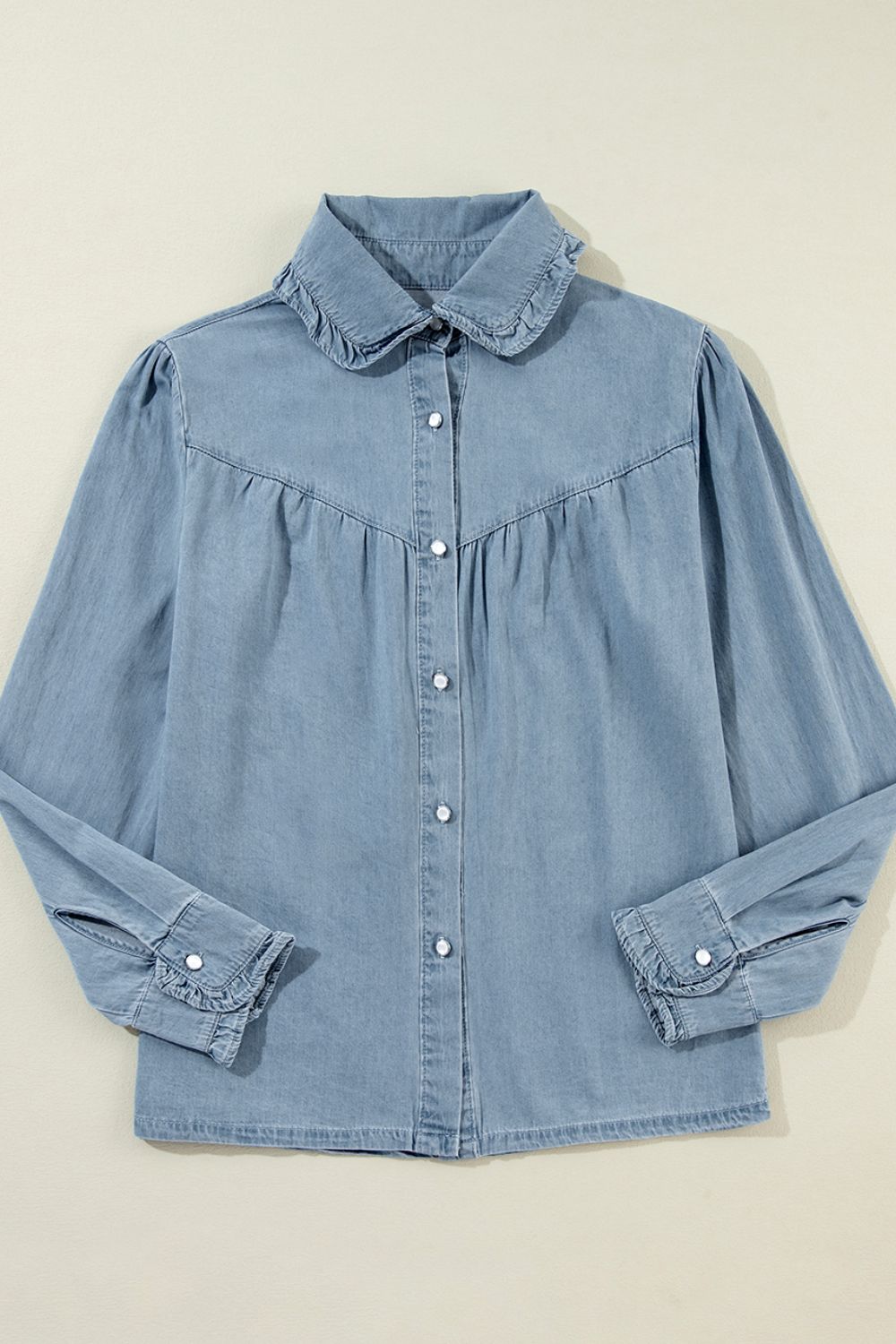 Indigo Dreams button-up blouse in medium blue denim with ruffled collar and cuffs.