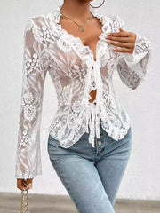 White lace tie-front blouse with ruffle trim and bell sleeves.